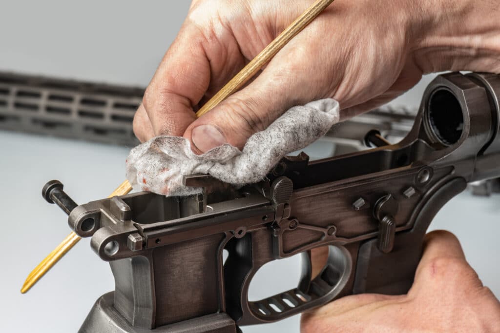 image of a person cleaning a firearm